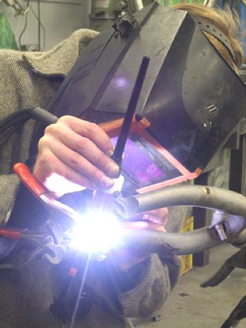 Framebuilder welding a bike frame