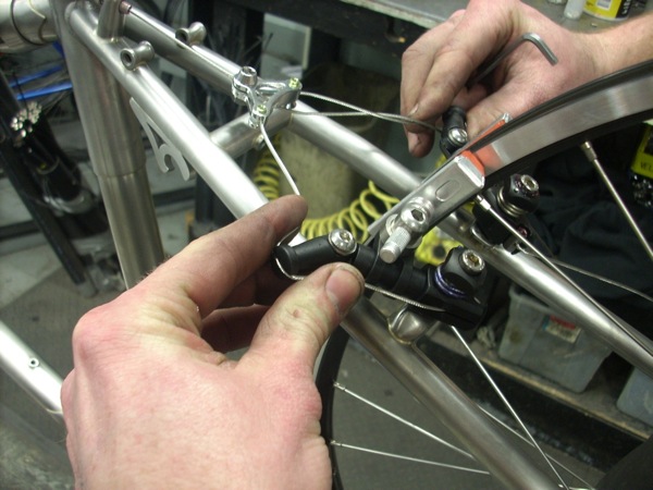 squeezing the cable at the adjustment arm