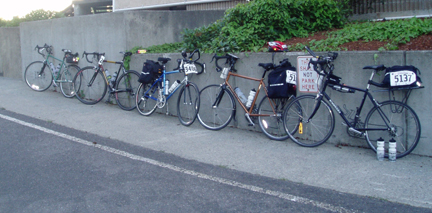 A Line of five Rodriguez Bikes against a wall